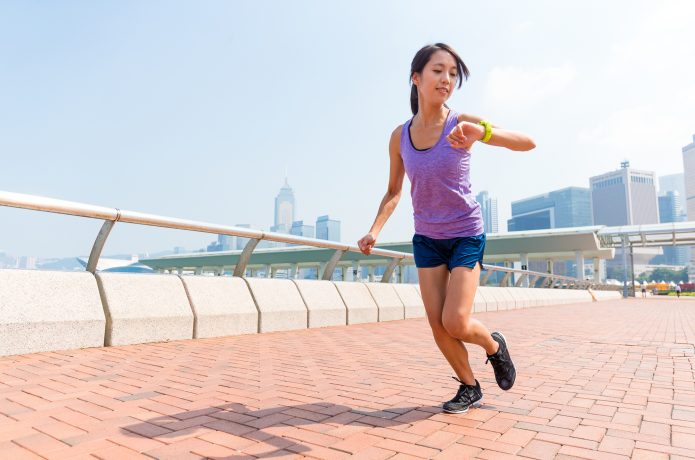 ペースをチェックする女性ランナー