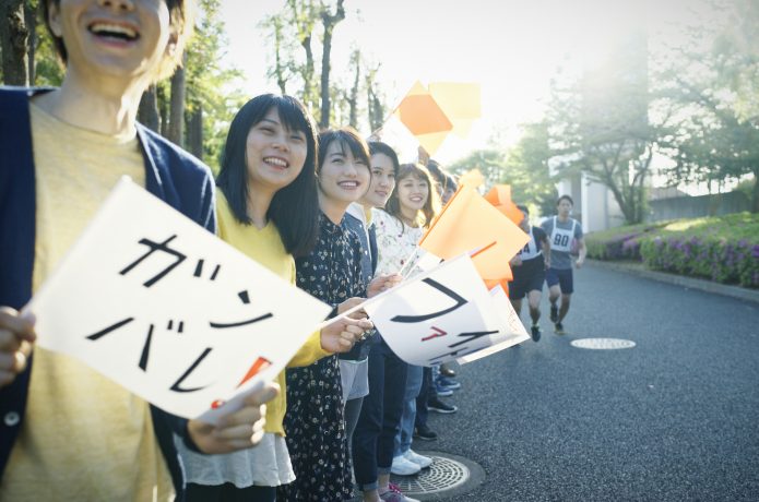 沿道でマラソンの応援をする人