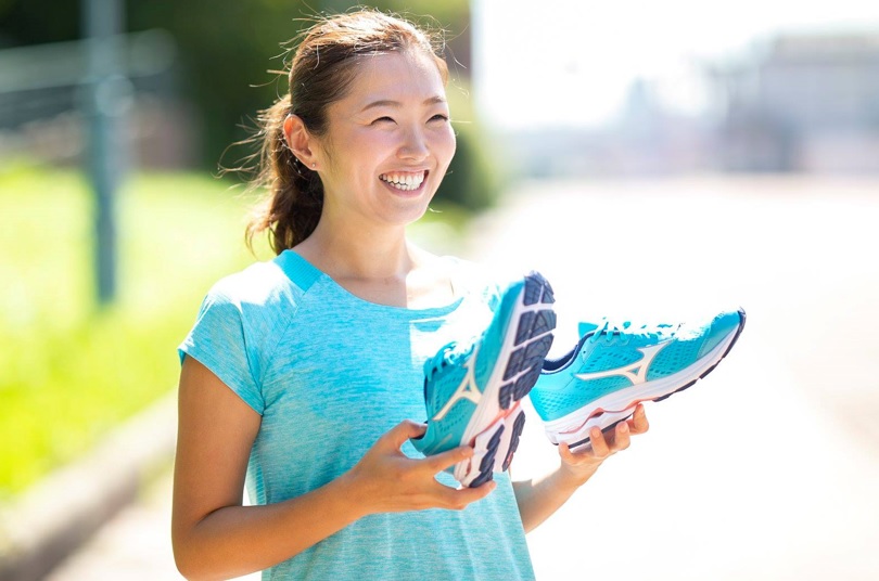 ミズノのランニングシューズを手に持つ女性