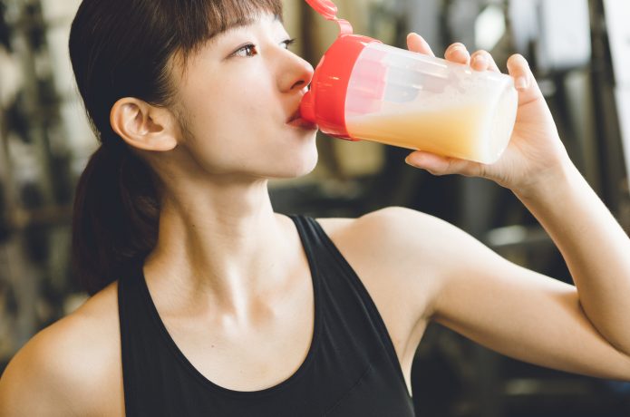 プロテインを飲む女性