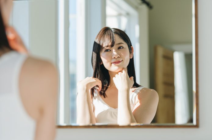鏡で身体を確認する女性